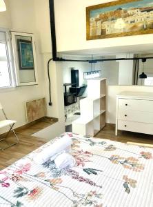 a room with a bed and a dresser in it at Loft A Mariña Lucense in San Ciprián +8 photos