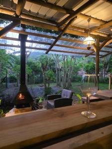 a wine glass sitting on a table with a fireplace at Le Pavillon, at La Petite Ferme 2BRoom with private fireplace in Grand Sable +18 photos