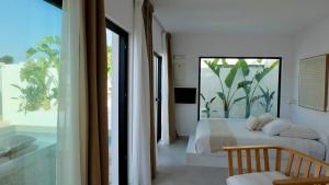 a bedroom with a bed and a large window at EBLI7 Hotel Boutique in Orihuela Costa