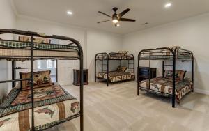 three bunk beds in a room with a ceiling fan at McElroy Manor - Luxury and comfort in Big Canoe in Jasper +41 photos