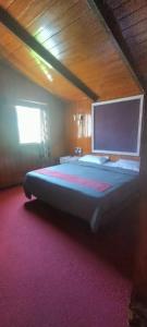 a bedroom with a large bed in a room at Nest 'N' Woods in Ooty