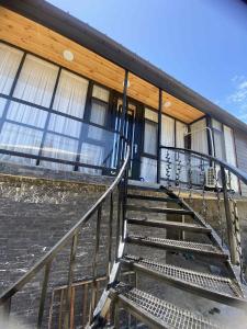 a building with a staircase in front of it at Green house Cottage in Itʼkhvisi +15 photos