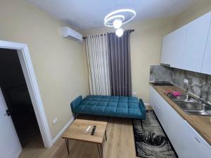 a small kitchen with a blue bench in a room at Green Escape Apartment Tirana in Tirana +9 photos