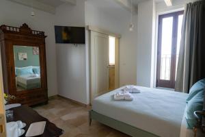 a bedroom with a bed with two pairs of shoes on it at Affittacamere La Creusa in Calosso +10 photos