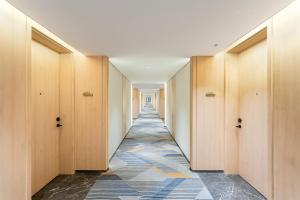 a hallway with wooden doors and a tile floor at Holiday Inn Express Lijiang Ancient Town by IHG in Lijiang