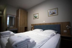 A bed or beds in a room at AquaSun Family Hotel