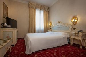 Postel nebo postele na pokoji v ubytování Hotel Stendhal