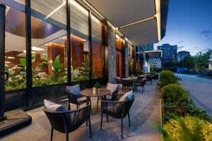 a patio with tables and chairs in a restaurant at IntercityHotel Chengdu New Exhibition Center in Chengdu