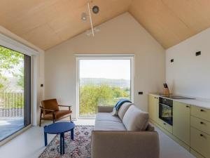 a living room with a couch and a large window at Enache's 217 in Valea lui Enache