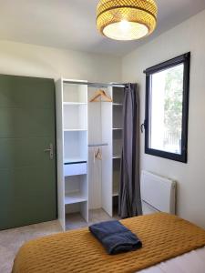 a bedroom with a bed and a closet and a window at Domaine de l'Envolée in Tourbes +67 photos