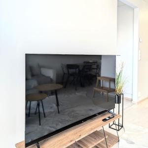 a living room with a tv on a wall at Henniina V Kotoisa - Free parking & Easy Check-in in Oulu
