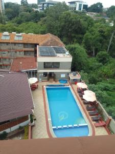 an overhead view of a swimming pool with umbrellas and chairs at The Zola lantana Westlands in Nairobi