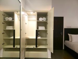 a bedroom with white shelves and a bed at Samadhi Lagoon Villa in Ratgama Hegoda