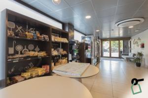 a room with a counter and a table in a store at Hotiday Firenze Guidoni in Florence
