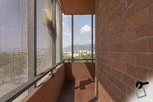 a balcony with a large window with a view at Hotiday Firenze Guidoni in Florence