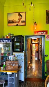 a shop with a yellow wall and a doorway at Hostel Taormina Homstel in Taormina