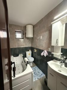 a bathroom with a tub and a toilet and a sink at Apartment Stana in Petrovac na Moru +29 photos