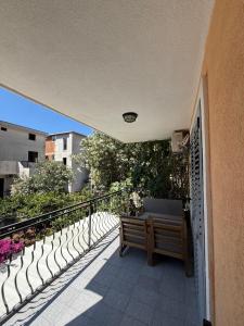 a bench sitting on the balcony of a building at Apartment Stana in Petrovac na Moru