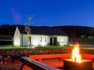 a house with a fire in front of it at Białe Domy - Stronie Śląskie in Stronie Śląskie +47 photos