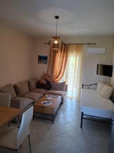 a living room with a couch and a table at Rousela apartment in Vasilikos