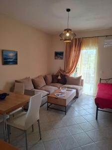 a living room with a couch and a table at Rousela apartment in Vasilikos