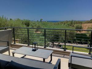 a balcony with a table and chairs and a view at Villa Onari in Alexandroupoli