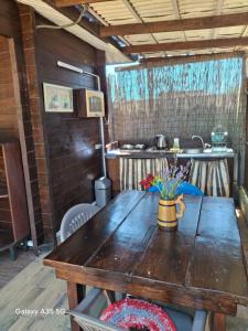 a wooden table with a vase of flowers on it at Relax and chill Villa in Chornomorsk