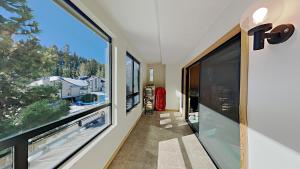a hallway with large windows in a house at Retro 3 Bed 3 Bath Condo with Mountain View! Steps to Canyon Lodge! Unit 210 at 1849 in Mammoth Lakes