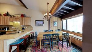 a kitchen with a large wooden table and chairs at Beautifully Remodeled 4 Bedroom Condo in Mammoth Lakes