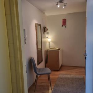 a living room with a chair and a mirror at Harju Rally with sauna in Jyväskylä