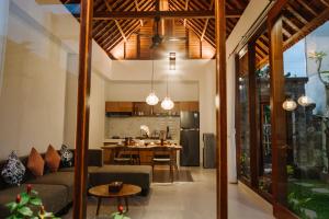 a living room with a couch and a table at Dream House Ubud in Ubud