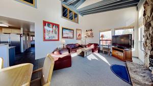 a living room with a flat screen tv and a couch at Large Spacious Upgraded 4 Bedroom Condo in Mammoth Lakes