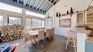 a dining room with a table and a pile of wood at Large Spacious Upgraded 4 Bedroom Condo in Mammoth Lakes