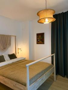 a bedroom with a bed and a chandelier at Elisaveta's Retreat. Come to feel the tranquility! in Râşnov +30 photos