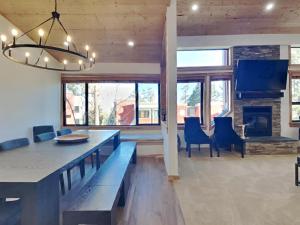 a living room with a dining table and a fireplace at Spacious 3 BR Condo with Loft in Mammoth Lakes +46 photos