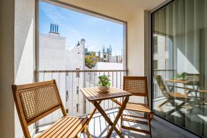 a balcony with a table and chairs and a view at A60 Apartment Hotel in Budapest