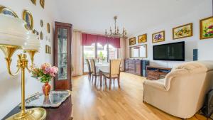 a living room with a table and a dining room at Świnoujście Platan, Sun & Snow in Świnoujście