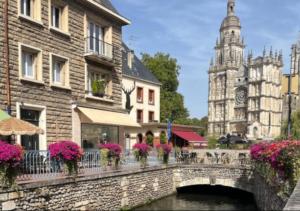 a bridge over a river with buildings and a church at L'icône du cinéma - Studio cosy - Gare - Centre-ville Evreux - Wifi in Évreux