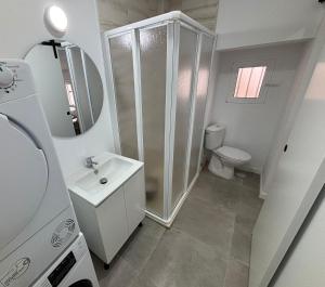 a white bathroom with a shower and a sink at Entresueños de Arcos in Arcos de la Frontera