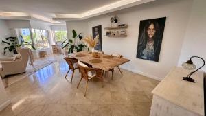 a living room with a wooden table and chairs at 2 bedrooms with swimming pool Nomad Dreams N 7 in Cascais