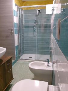 a bathroom with a toilet and a sink and a shower at Marina Club in Giardini Naxos