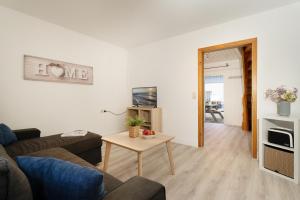 a living room with a couch and a table at Gästehaus Sulsdorf Wohnung 15 in Sulsdorf auf Fehmarn +32 photos