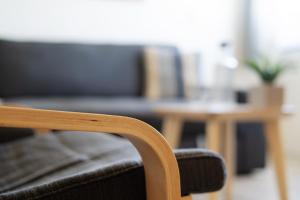 a chair and a table with a couch at Gästehaus Sulsdorf Wohnung 7 in Sulsdorf auf Fehmarn +29 photos