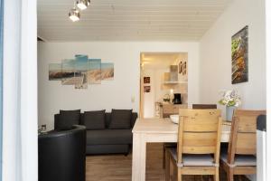 a living room and dining room with a couch and a table at Gästehaus Sulsdorf Wohnung 8 in Sulsdorf auf Fehmarn