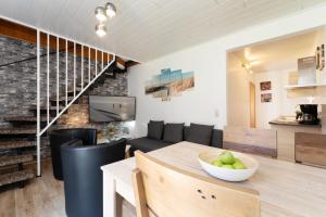 a kitchen and living room with a table and a couch at Gästehaus Sulsdorf Wohnung 8 in Sulsdorf auf Fehmarn
