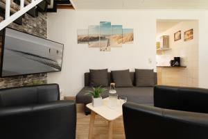 a living room with a couch and a table at Gästehaus Sulsdorf Wohnung 8 in Sulsdorf auf Fehmarn +36 photos