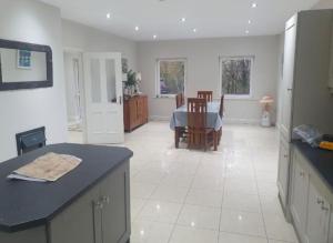 a kitchen with a table and a dining room at Tigh Dawros - Charming 4-bedroom house with WiFi in beautiful Kenmare, Kerry in Dinish Island