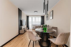 a living room with a table and chairs at Summer5 by Grand Apartments in Gdańsk +6 photos