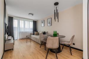 a living room with a couch and a table at Summer5 by Grand Apartments in Gdańsk