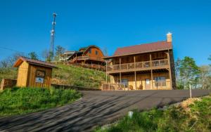 a house on top of a hill next to a road at Hot tub and game room! - Black Bear Crossing in Gatlinburg